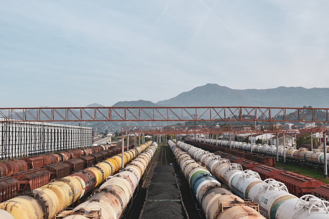 services-04 Aerial view of cargo trains lined up at a large railway yard under a blue sky.
