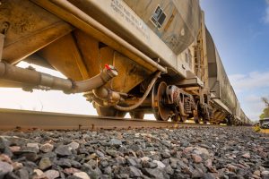 Low-angle view of a freight train on railway tracks in Reads Landing, Minnesota. Industrial transportation scene.