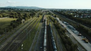 Aerial shot of freight train on tracks with surrounding landscape in Offenburg, Germany.